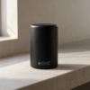 Kokuyō Chazutsu matte black matcha canister on a concrete ledge